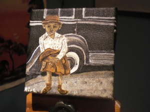 Mini car painting with a child in front holding his coat